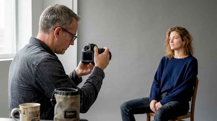 A photographer conducts portrait sessions in their studio.
